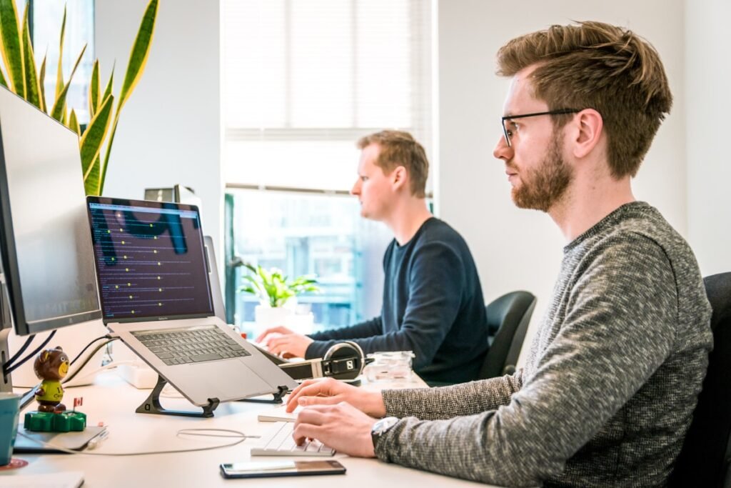 Team reviewing a website project around a laptop